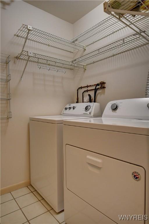 1175 Youngs Rd Unit C, Amherst, NY 14221 - washroom with washer and dryer and light tile patterned flooring