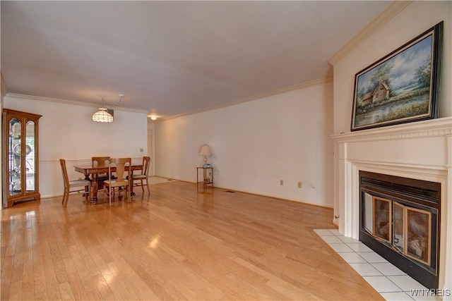1175 Youngs Rd Unit C, Amherst, NY 14221 - dining room featuring light wood-style floors, crown molding, and a fireplace with flush hearth