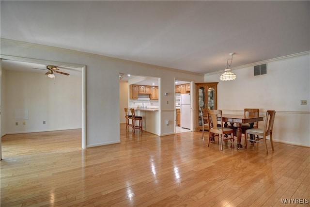 1175 Youngs Rd Unit C, Amherst, NY 14221 - dining space featuring ceiling fan, light wood-style floors, and ornamental molding