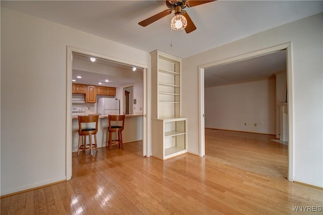 1175 Youngs Rd Unit C, Amherst, NY 14221 - unfurnished living room featuring ceiling fan, light wood finished floors, and built in shelves