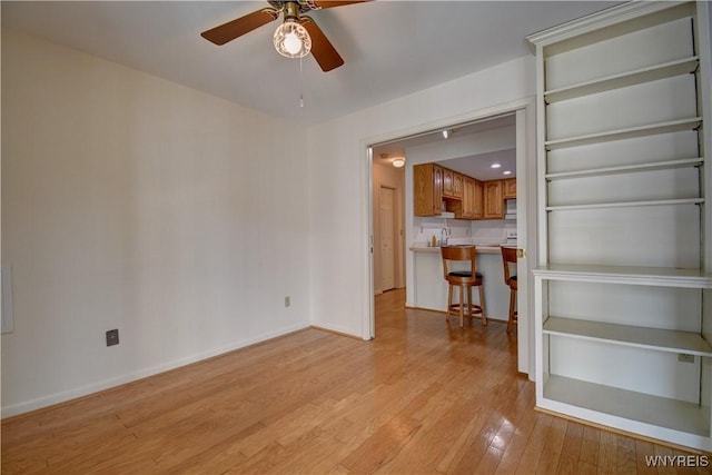 1175 Youngs Rd Unit C, Amherst, NY 14221 - unfurnished living room with light wood-style flooring and ceiling fan
