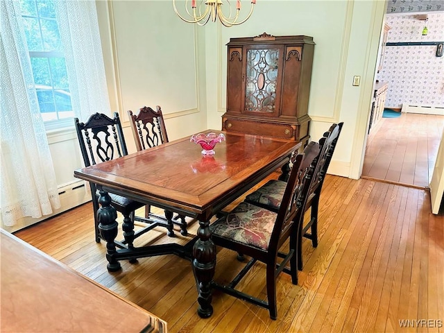 2721 Bowen Rd, Elma, NY 14059 - dining space with light wood-type flooring, wallpapered walls, a chandelier, and baseboard heating