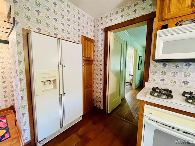 2721 Bowen Rd, Elma, NY 14059 - kitchen featuring white appliances, dark wood finished floors, wallpapered walls, light countertops, and brown cabinets