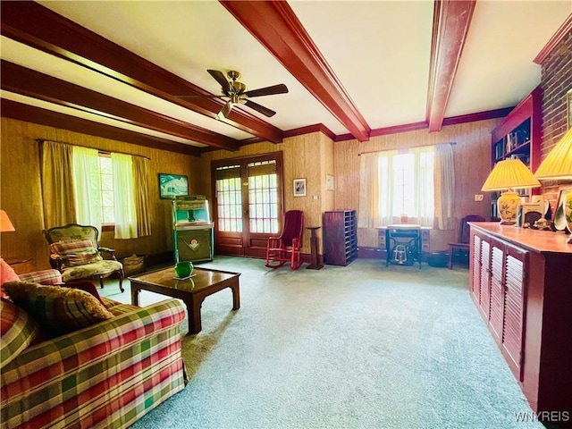 2721 Bowen Rd, Elma, NY 14059 - living area with healthy amount of natural light, beam ceiling, a ceiling fan, carpet floors, and wood walls