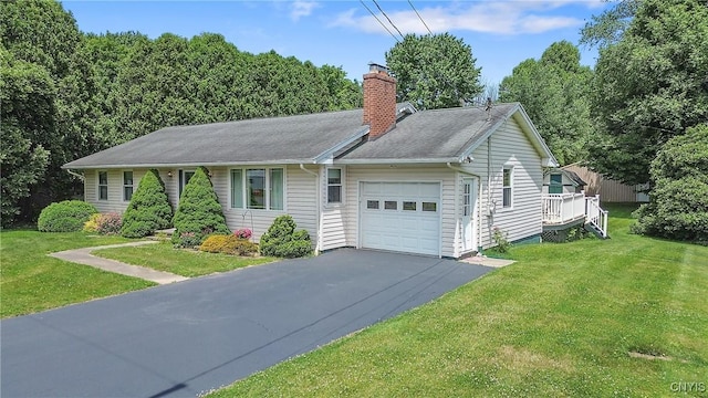 206 Oswego River Rd, Schroeppel, NY 13135 - ranch-style house with an attached garage, a chimney, asphalt driveway, and a front yard
