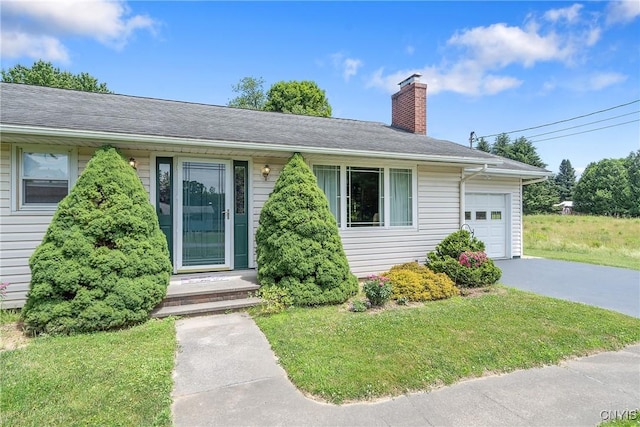 206 Oswego River Rd, Schroeppel, NY 13135 - single story home featuring a chimney, a garage, asphalt driveway, and a front yard