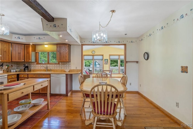 206 Oswego River Rd, Schroeppel, NY 13135 - kitchen featuring white appliances, a chandelier, light wood-type flooring, backsplash, and light countertops