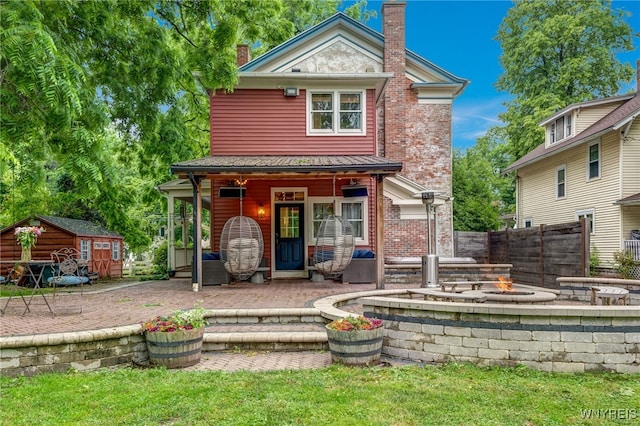 626 Main St, Porter, NY 14174 - view of front of property featuring a chimney, an outdoor fire pit, a shed, and a patio area