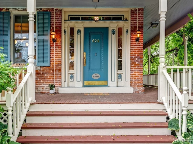 626 Main St, Porter, NY 14174 - entrance to property featuring a porch and brick siding