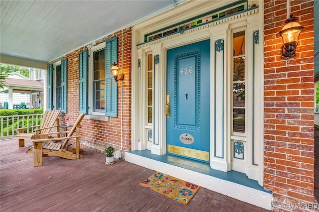 626 Main St, Porter, NY 14174 - property entrance with covered porch and brick siding