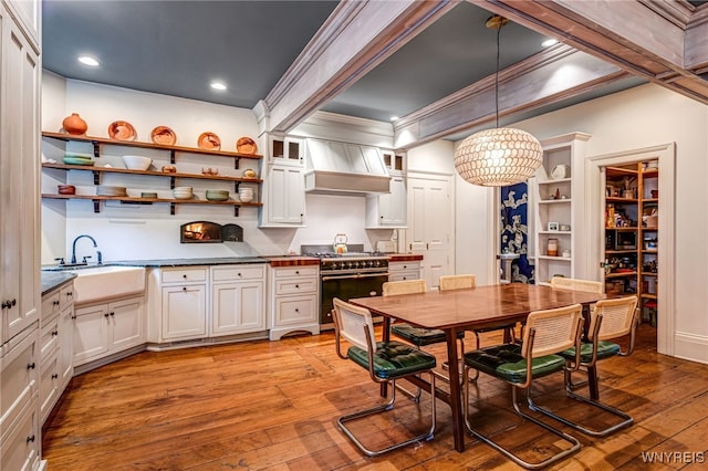 626 Main St, Porter, NY 14174 - kitchen with range with two ovens, open shelves, custom range hood, light wood finished floors, and dark countertops