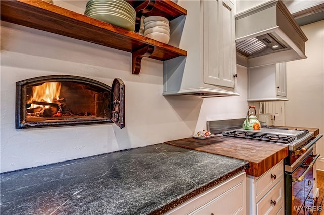 626 Main St, Porter, NY 14174 - kitchen featuring high end stove, open shelves, white cabinetry, custom range hood, and butcher block counters