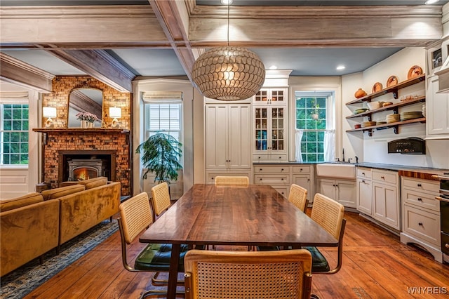626 Main St, Porter, NY 14174 - dining area featuring hardwood / wood-style floors, beamed ceiling, and a fireplace