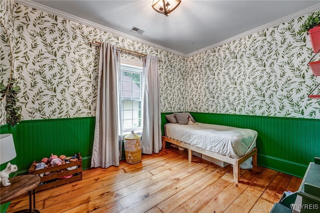 626 Main St, Porter, NY 14174 - bedroom featuring wallpapered walls, wainscoting, hardwood / wood-style floors, and ornamental molding