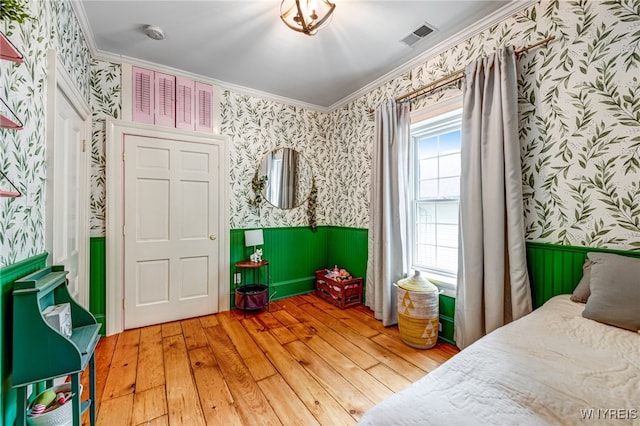 626 Main St, Porter, NY 14174 - bedroom featuring wallpapered walls, light wood finished floors, a wainscoted wall, and crown molding