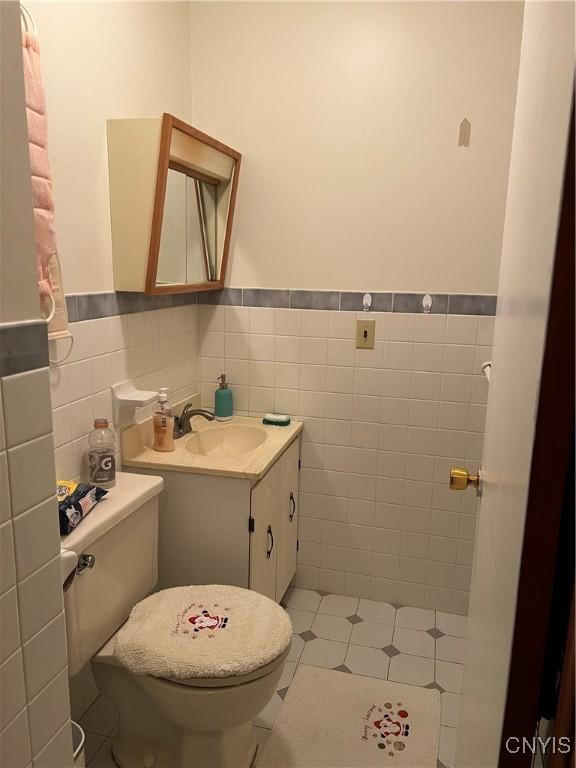4067 Taylor Rd, Pompey, NY 13078 - half bathroom featuring tile walls, vanity, wainscoting, and tile patterned floors