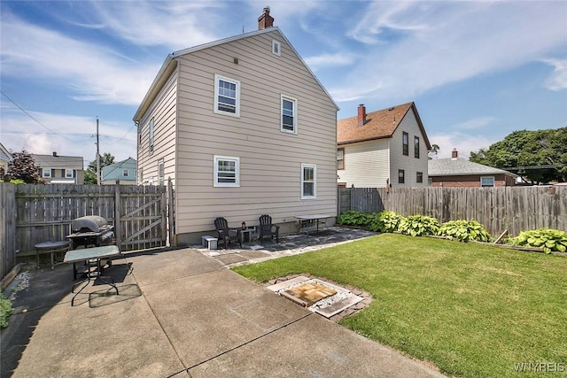 2910 Weston Ave, Niagara Falls, NY 14305 - rear view of property with a patio, a fenced backyard, a chimney, and a gate