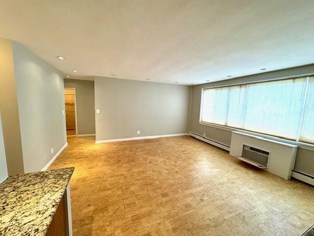 1000 E Ave Unit Un208, Rochester, NY 14607 - spare room with a baseboard heating unit and recessed lighting
