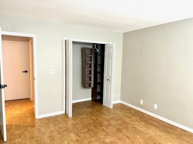 1000 E Ave Unit Un208, Rochester, NY 14607 - unfurnished bedroom featuring a closet and light floors
