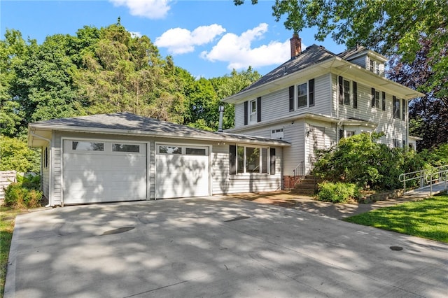 234 Pine Grove Ave, Irondequoit, NY 14617 - view of front facade featuring a chimney, a garage, and concrete driveway