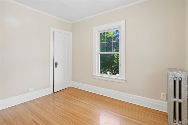 234 Pine Grove Ave, Irondequoit, NY 14617 - unfurnished room featuring radiator, light wood-style floors, and crown molding