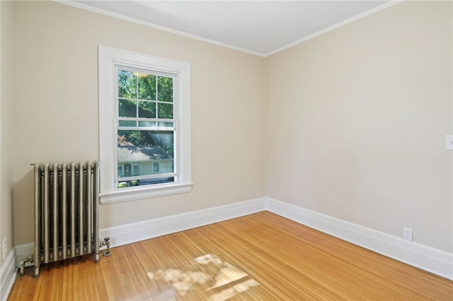 234 Pine Grove Ave, Irondequoit, NY 14617 - spare room featuring radiator heating unit, wood finished floors, and crown molding