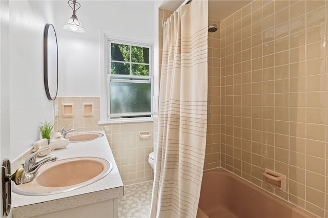 234 Pine Grove Ave, Irondequoit, NY 14617 - full bath with tile walls, double vanity, shower / bathtub combination with curtain, and a wainscoted wall