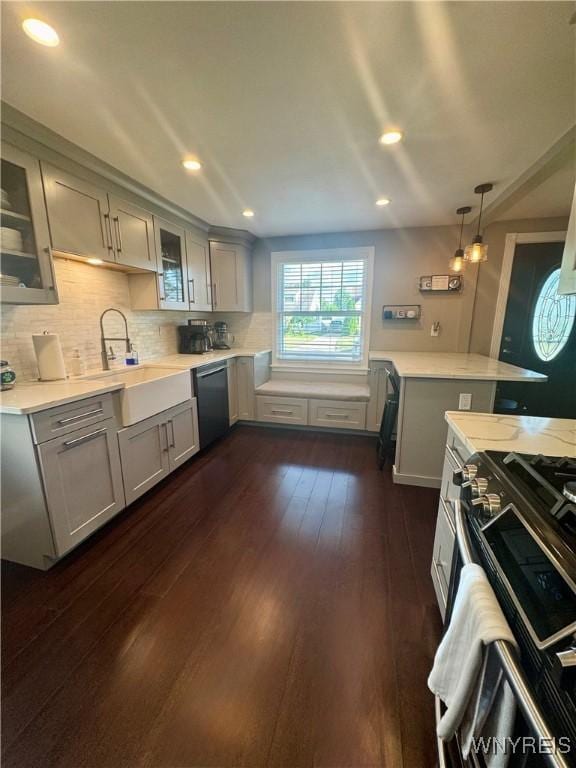149 Wrexham Ct S, Tonawanda, NY 14150 - kitchen with gray cabinetry, light countertops, range with gas stovetop, glass insert cabinets, and recessed lighting