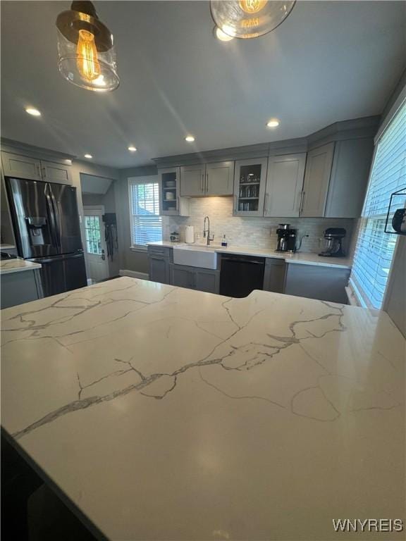 149 Wrexham Ct S, Tonawanda, NY 14150 - kitchen with fridge with ice dispenser, gray cabinets, black dishwasher, tasteful backsplash, and light stone countertops