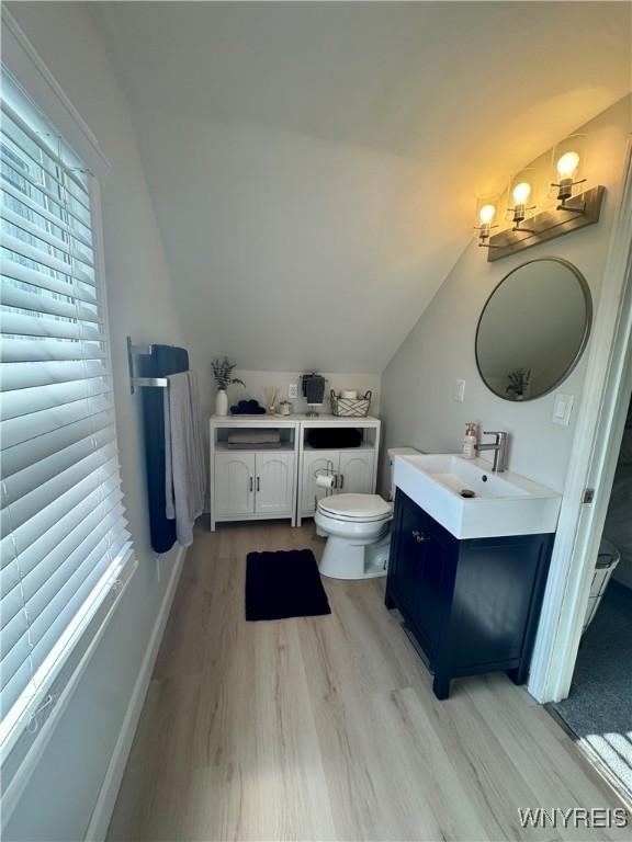 149 Wrexham Ct S, Tonawanda, NY 14150 - bathroom featuring vanity, wood finished floors, and lofted ceiling