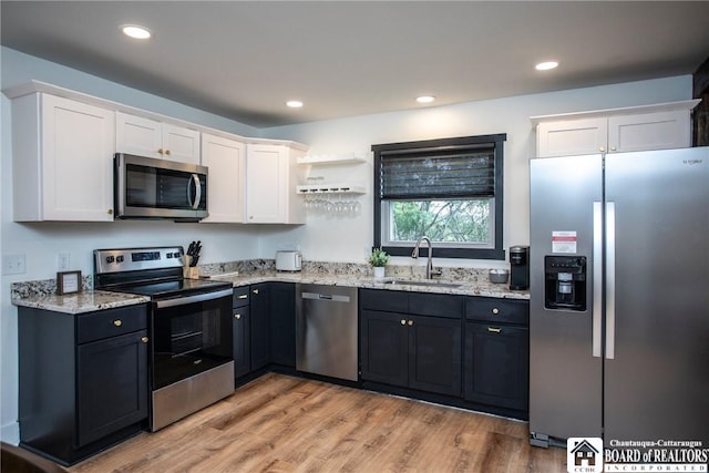 6064 Nys Rte 242 E, Ellicottville, NY 14731 - kitchen with stainless steel appliances, white cabinets, light stone countertops, light wood finished floors, and open shelves