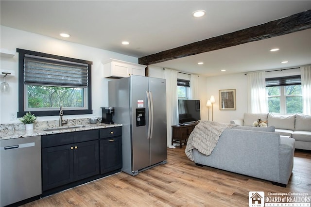 6064 Nys Rte 242 E, Ellicottville, NY 14731 - kitchen featuring stainless steel appliances, light stone countertops, open floor plan, beamed ceiling, and plenty of natural light
