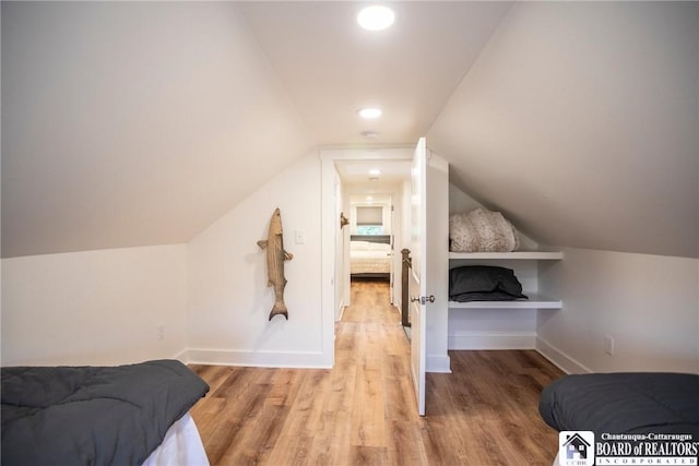 6064 Nys Rte 242 E, Ellicottville, NY 14731 - bedroom with light wood-style flooring and vaulted ceiling