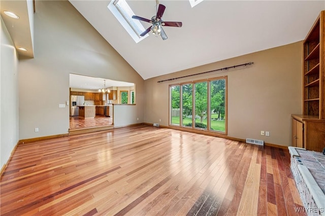 100 Hunt Club Cir, Amherst, NY 14051 - unfurnished living room featuring a skylight, high vaulted ceiling, light wood finished floors, ceiling fan, and a chandelier