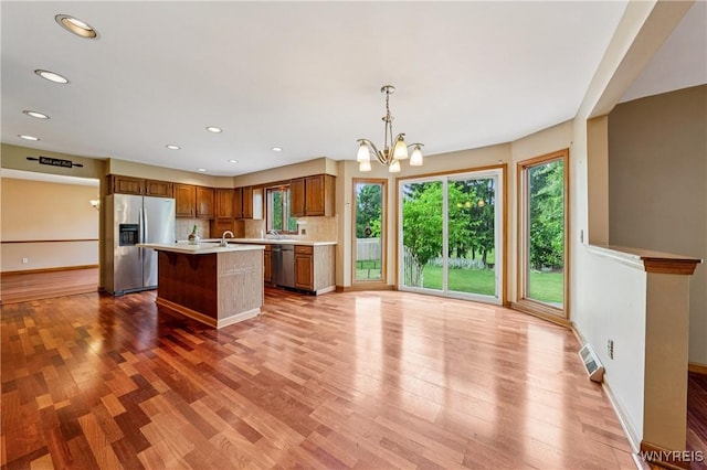 100 Hunt Club Cir, Amherst, NY 14051 - kitchen featuring appliances with stainless steel finishes, light countertops, light wood finished floors, a chandelier, and recessed lighting