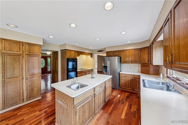 100 Hunt Club Cir, Amherst, NY 14051 - kitchen with black appliances, a center island with sink, dark wood-style flooring, light countertops, and recessed lighting