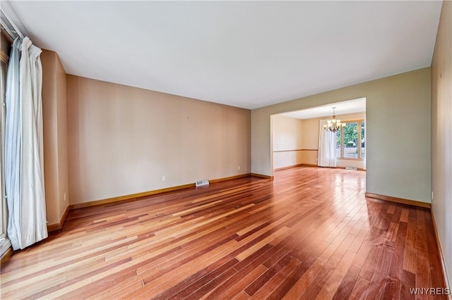 100 Hunt Club Cir, Amherst, NY 14051 - unfurnished room featuring a chandelier and hardwood / wood-style flooring