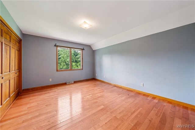 100 Hunt Club Cir, Amherst, NY 14051 - unfurnished bedroom with light wood finished floors, lofted ceiling, and a closet