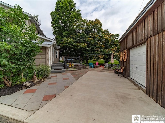 6295 Stockton Hartfield Rd, Chautauqua, NY 14728 - view of patio with a garage