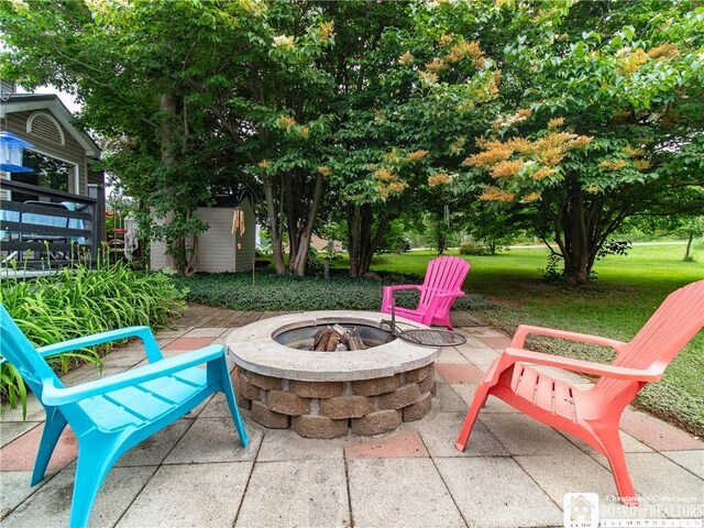 6295 Stockton Hartfield Rd, Chautauqua, NY 14728 - view of patio / terrace featuring a fire pit and a storage unit