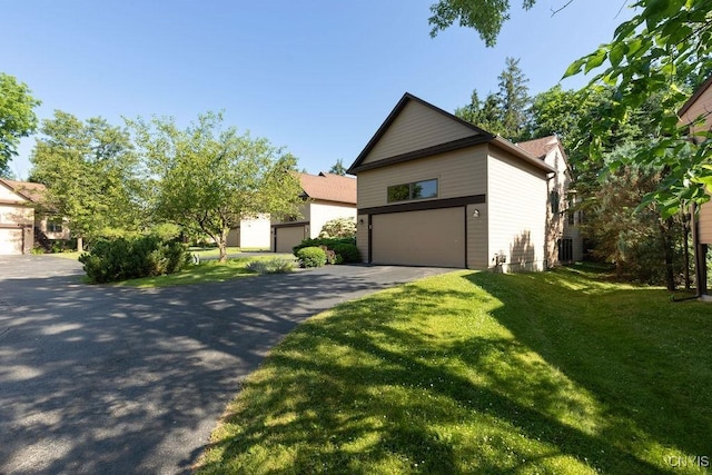 42 Nursery Ln, Syracuse, NY 13210 - view of front of house with a front yard, an attached garage, and asphalt driveway