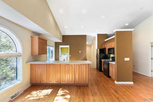 42 Nursery Ln, Syracuse, NY 13210 - kitchen with black appliances, a peninsula, washer / dryer, plenty of natural light, and recessed lighting