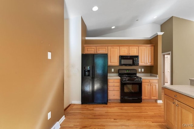 42 Nursery Ln, Syracuse, NY 13210 - kitchen featuring black appliances, light countertops, vaulted ceiling, light wood-style floors, and recessed lighting