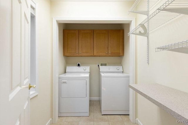 42 Nursery Ln, Syracuse, NY 13210 - laundry area featuring cabinet space, washing machine and clothes dryer, and light tile patterned flooring