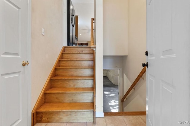 42 Nursery Ln, Syracuse, NY 13210 - staircase featuring tile patterned flooring and baseboards