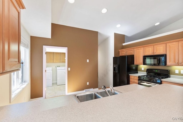 42 Nursery Ln, Syracuse, NY 13210 - kitchen with black appliances, washing machine and clothes dryer, vaulted ceiling, light countertops, and recessed lighting