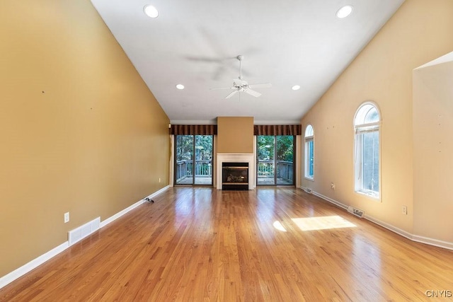 42 Nursery Ln, Syracuse, NY 13210 - unfurnished living room featuring ceiling fan, light wood-style floors, a fireplace, recessed lighting, and lofted ceiling