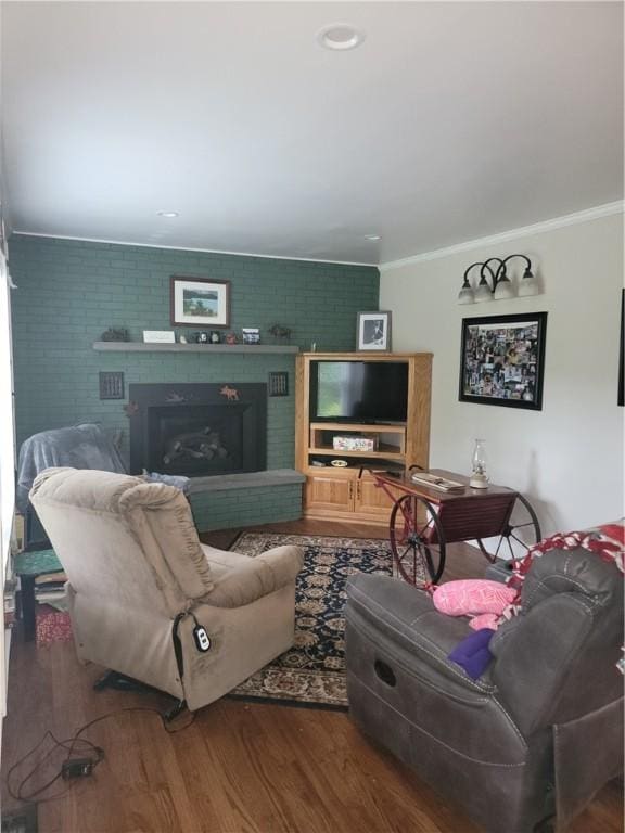 244 State Highway 320, Norwich, NY 13815 - living area featuring crown molding, wood finished floors, a fireplace, and brick wall