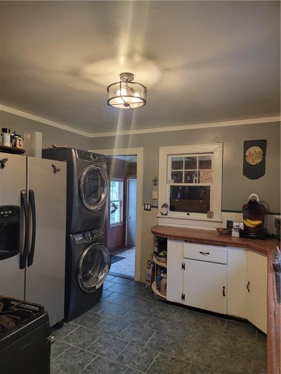 244 State Highway 320, Norwich, NY 13815 - kitchen with butcher block countertops, stacked washing machine and dryer, fridge with ice dispenser, white cabinets, and dark stone finish flooring