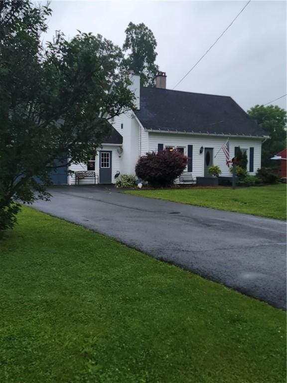 244 State Highway 320, Norwich, NY 13815 - view of front of house with a chimney, driveway, and a front lawn